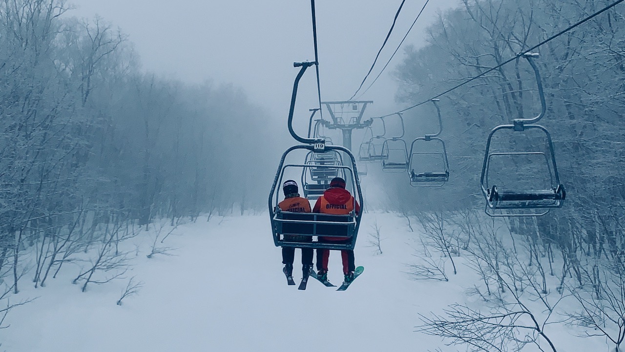 Two people sitting on lift