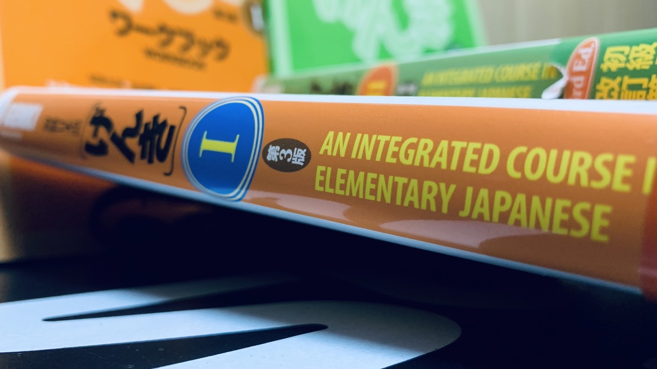 Genki Japanese textbook on their side.