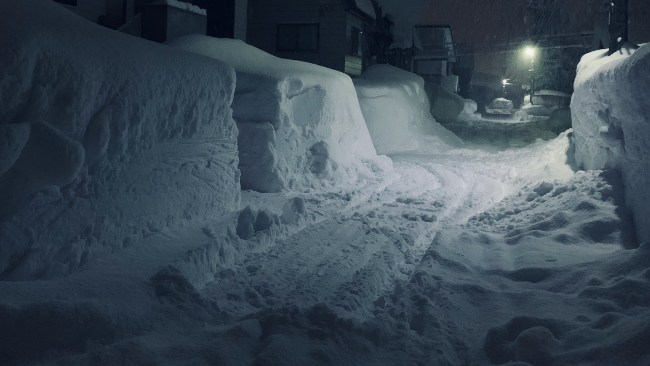 Snowy side road at night